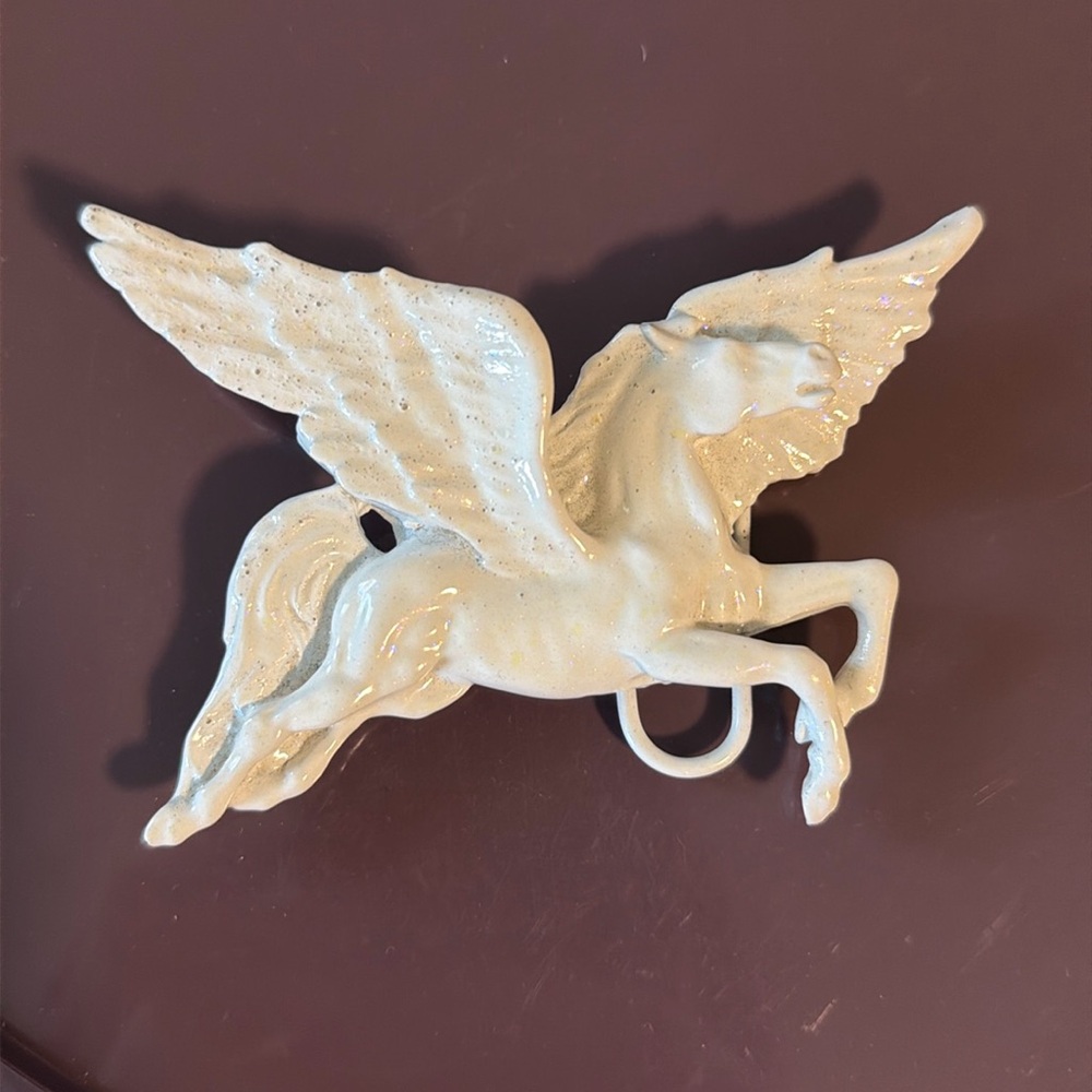 Flying Horse Belt Buckle in lightly iridescent white powder coated metal